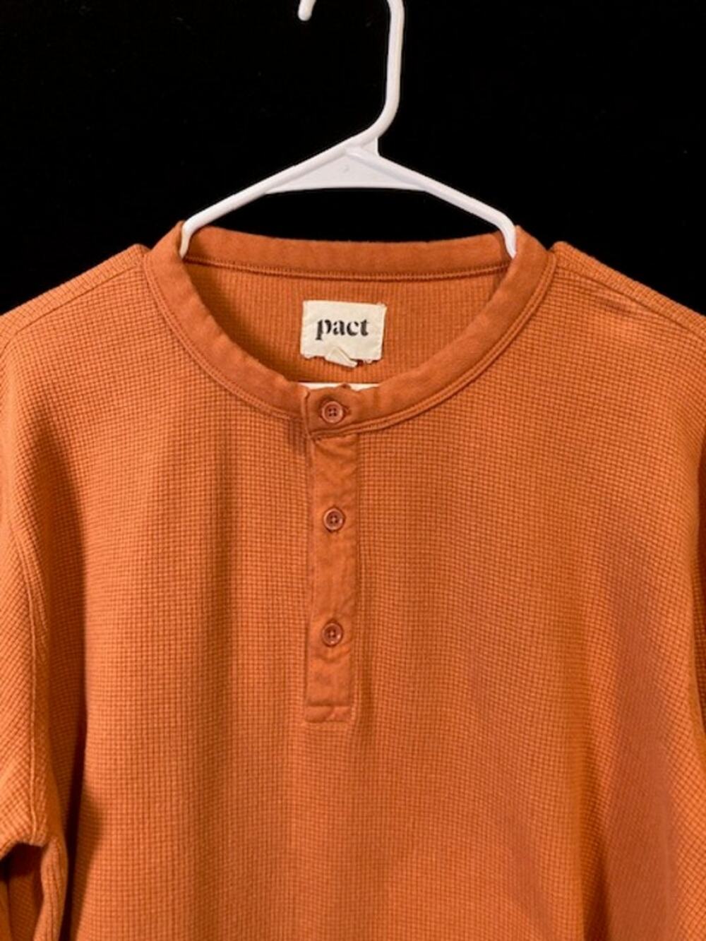 Pact men's orange waffle knit long sleeve henley shirt.